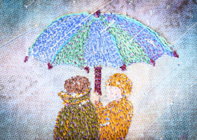 embroidery of two people sharing an umbrella
